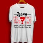 A white t-shirt with the words " learn from now to love ".